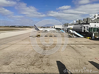 Exterior view of the runway and lift and maintenance of aircraft at Lisbon airport with Lufthansa airplane, cargo working Editorial Stock Photo