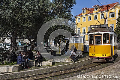 Lisbon street with traditional yellow trams Editorial Stock Photo
