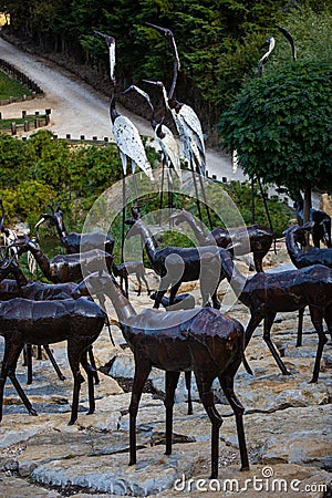 Lisbon, Portugal: 09/08/2020: Hiding part of the Buddha Garden with the african and wild animals sculptures crocodile, giraffe, Editorial Stock Photo
