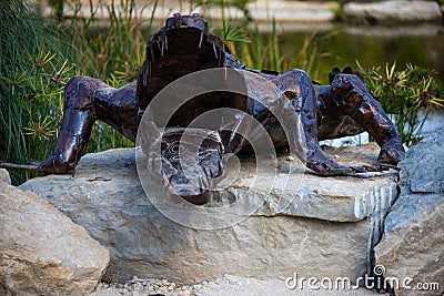 Lisbon, Portugal: 09/08/2020: Hiding part of the Buddha Garden with the african and wild animals sculptures crocodile, giraffe, Editorial Stock Photo