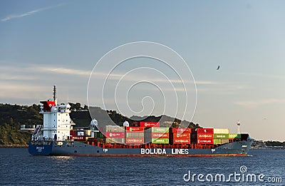 LISBON, PORTUGAL - JULY, 06, 2018: Cargo ship floating on the river Tagus in Lisbon, Portugal. Editorial Stock Photo