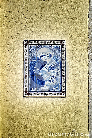 Saint Anthony painted on a tile on a facade of Lisbon Editorial Stock Photo
