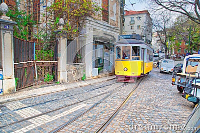 Famous narrow gauge yellow Lisbon tram lines, a landmark Lisbon tourist attraction Stock Photo