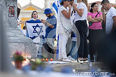 Lisbon, Portugal, October 10, 2023, People with the Israel flags standing at the memorial to the fallen Israelis in Editorial Stock Photo