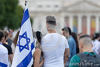 Lisbon, Portugal October 10, 2023. People at a rally in support of Israel hug and hold Israeli flags Editorial Stock Photo