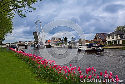 Lisse, the Netherlands, May 18, 2021. Motorboats sail through a raised bridge on a water channel in the Dutch village of Lisse Stock Photo