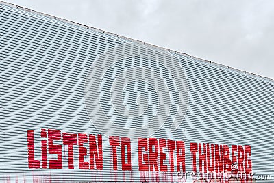 Listen to Greta Thunberg, a text message on a wall in Copenhagen Editorial Stock Photo