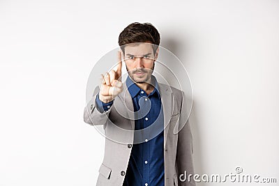 Listen to me. Serious male ceo manager showing one finger, scolding or telling to stop, tell no, hold right there sign Stock Photo