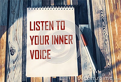 Listen to your inner voice - inspiring phrase on a notebook. Confidence, intuition Stock Photo