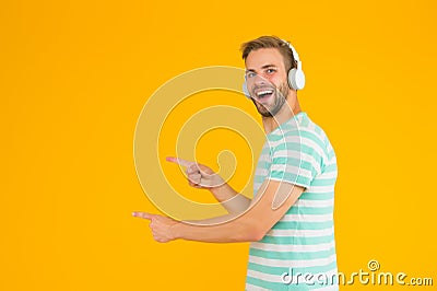Listening heroic music feeling more positive motivated active and inspired. Man pointing copy space. Perfect sound Stock Photo