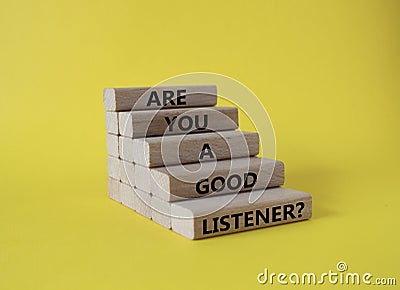 Listening skills symbol. Wooden blocks with words Are you a good Listener. Beautiful yellow background. Business and Are you a Stock Photo