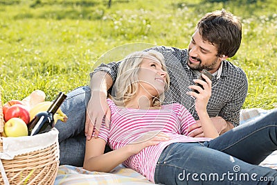 Listening to the music together. Loving young couple listening t Stock Photo