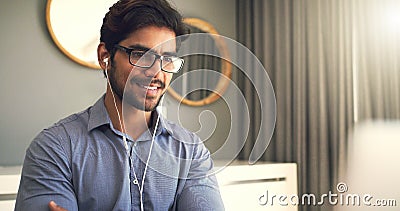Listening to music while working soothes him. a handsome young businessman working at home. Stock Photo