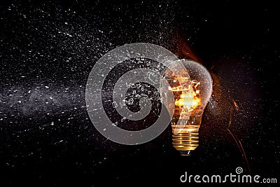 lit bulb hit by projectile Stock Photo