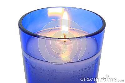 Lit Candle In Blue Glass Close Up Stock Photo