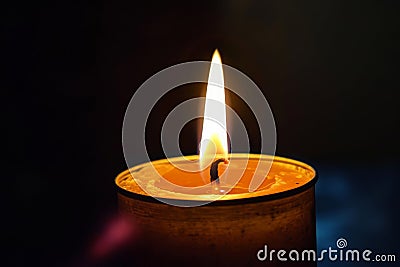 A lit candle flickers against a solid black background, casting a warm glow, Binary flame for a candle on a black background, AI Stock Photo