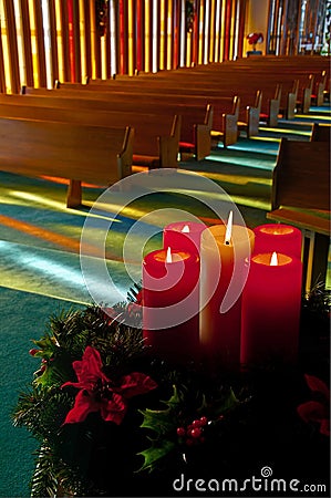 Lit Christmas Candles and Wreath in Empty Church Stock Photo