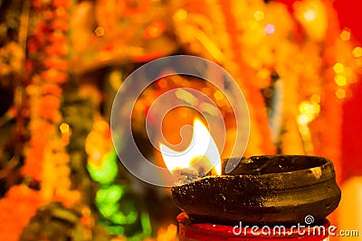 Lit clay lamp on top of a clay stand or worship idol durgapuja india diwali Stock Photo