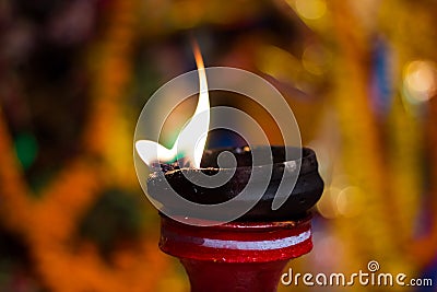 Lit clay lamp on top of a clay stand or worship idol durgapuja india diwali Stock Photo