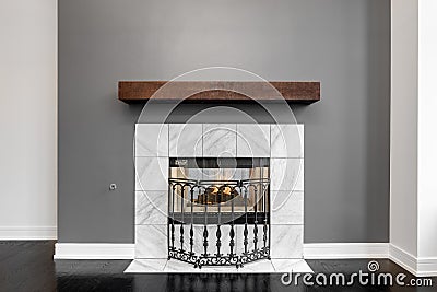 A lit fireplace surrounded by white tiles. Editorial Stock Photo