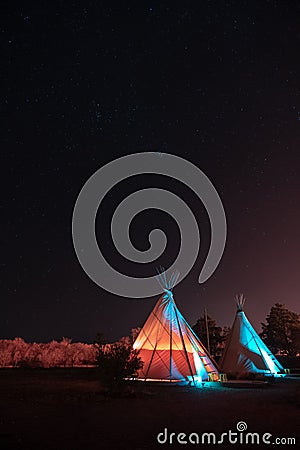 Lit up teepees at night under a sky of stars in Marfa, Texas Stock Photo