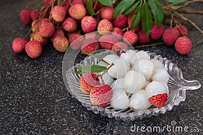 Litchi fruits. Fresh juicy lychee fruit on a glass plate. Peeled lychee fruit. Stock Photo