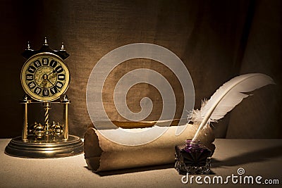 Literature concept. Old inkstand with feather near scroll and vintage clock on canvas background Stock Photo