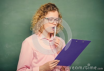 Literature teacher read composition. Read impressing resume. School project. Tutor checking homework. Woman smart lady Stock Photo
