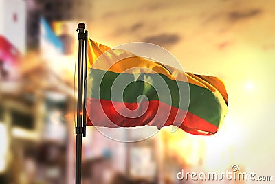 Lithuania Flag Against City Blurred Background At Sunrise Backlight Stock Photo