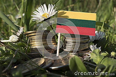 Lithuanian flag with stack of money coins with grass Stock Photo