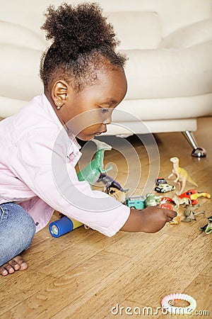 Litle cute sweet african-american girl playing happy with toys at home, lifestyle children concept Stock Photo