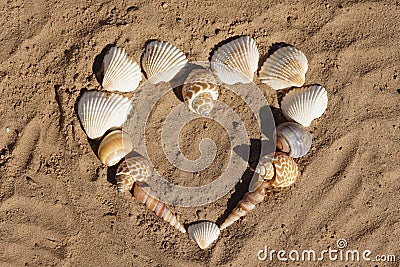 A littel heart out of seashells on the beach Stock Photo