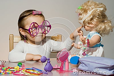 Little adorable girl playing with doll Stock Photo