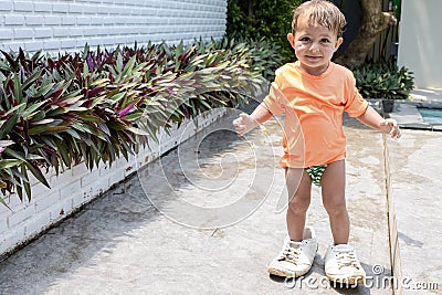 Little adorable toddler baby trying on adult sneakers Stock Photo