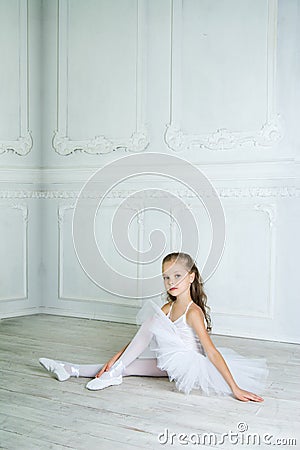 A little adorable young ballerina in a playful mood in the inter Stock Photo