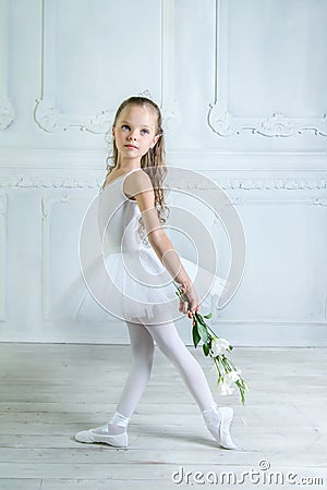 A little adorable young ballerina in a playful mood in the inter Stock Photo