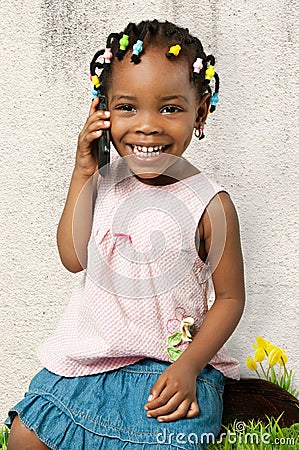 Little african american girl talking to the phone Stock Photo