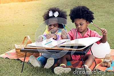 Little african boy and girl playing in backyard Stock Photo