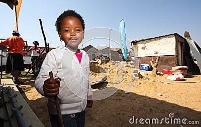 Little African Girl playing in the backyard building site in a Soweto Township Editorial Stock Photo