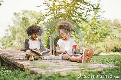 Little child reading with friend Stock Photo