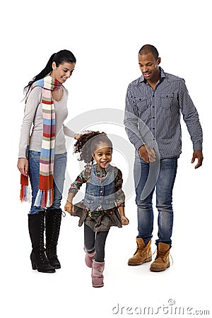 Little afro girl running parents watching Stock Photo