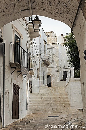 Little alley in the medieval white village of Ostuni at sunset Editorial Stock Photo