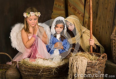 Little angel in nativity scene Stock Photo