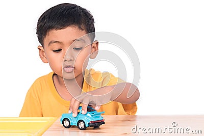 Little asian boy child kid preschooler playing with blue ca Stock Photo