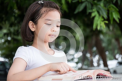Little Asian child reading a book Stock Photo