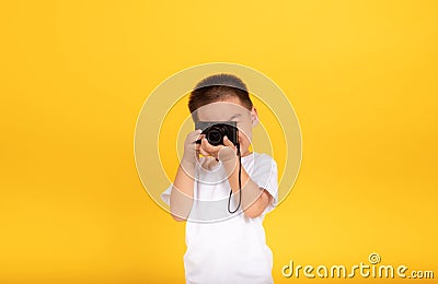 Little asian children boy photographer learning holding digital camera taking a photo shoot Stock Photo