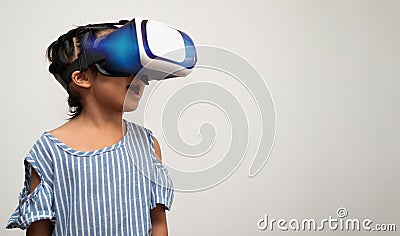 Little Asian girl child with virtual reality headset is exciting for new experiencing. Concept of 3D gadget technology and virtual Stock Photo