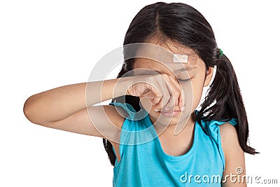 Little asian girl cry with bandage on forehead Stock Photo