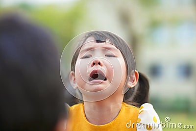 Little asian girl crying and look at her parents Stock Photo