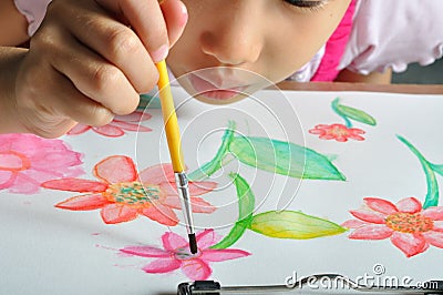 Little asian girl hand paint her watercolor picture Stock Photo